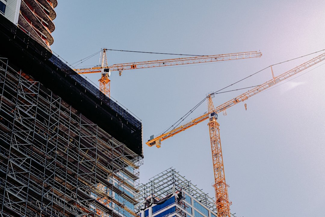 Construction site with cranes and steel structure